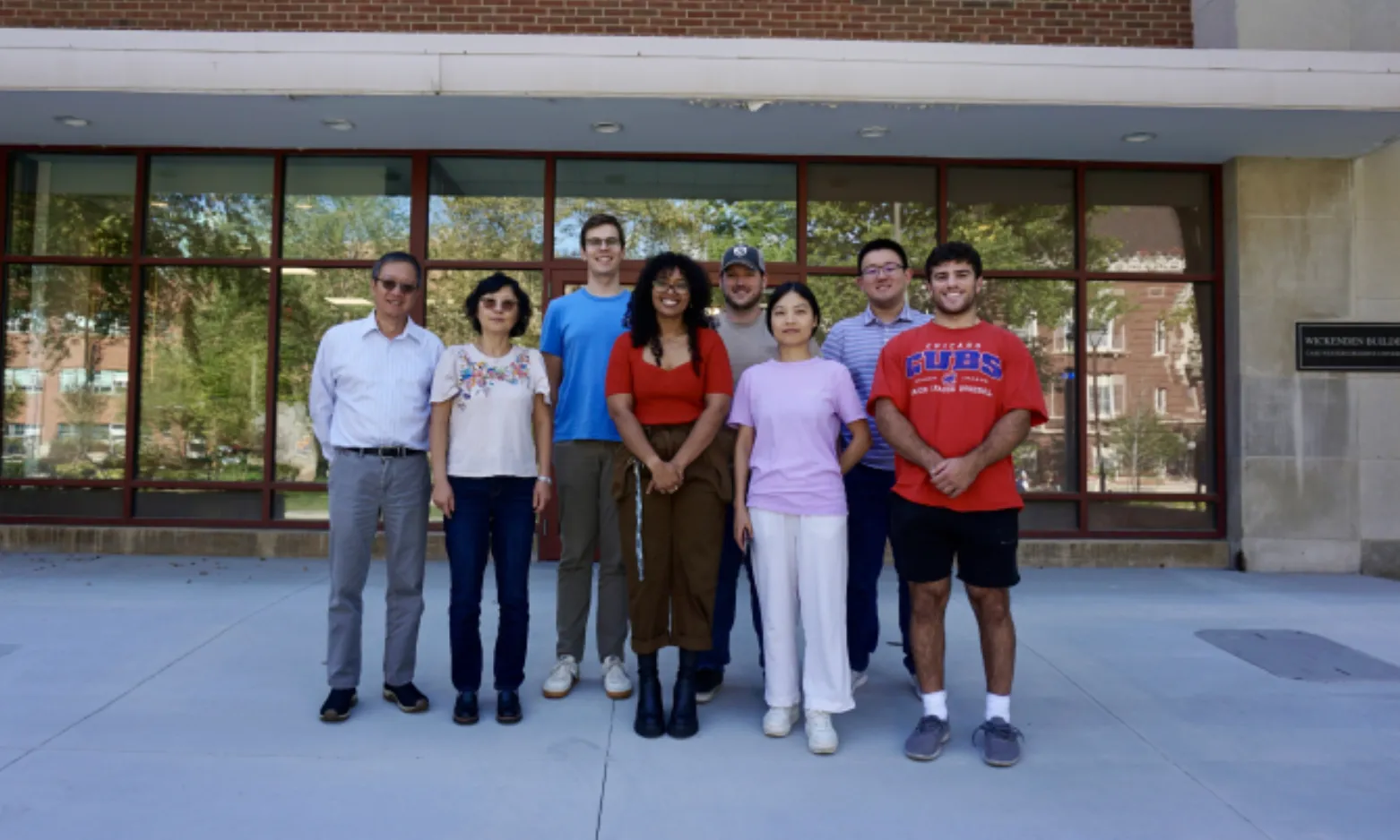 The lab group standing together outside the Wickenden Building